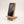 White oak phone holder holding an iPhone 14 Pro