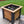 Square cedar planter box with black legs, planted with pansies